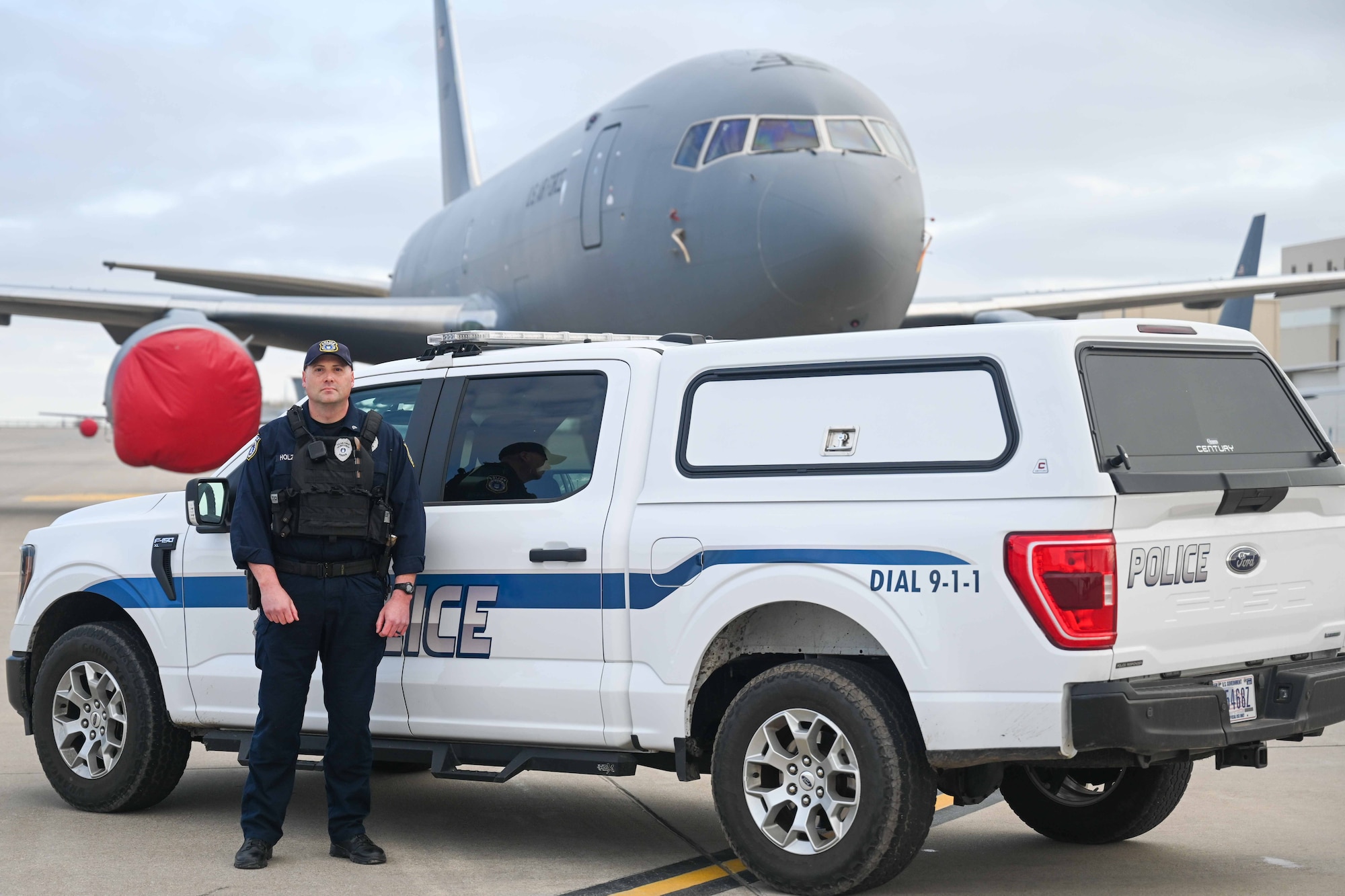 Officer Joseph Holzman, 22nd Security Forces Squadron supervisory police officer, guards the flightline March 31, 2025, at McConnell Air Force Base, Kansas. The Department of the Air Force (DAF) officers work alongside active-duty U.S. Air Force security forces members to keep the base safe. (U.S. Air Force photo by Senior Airman William Lunn)
