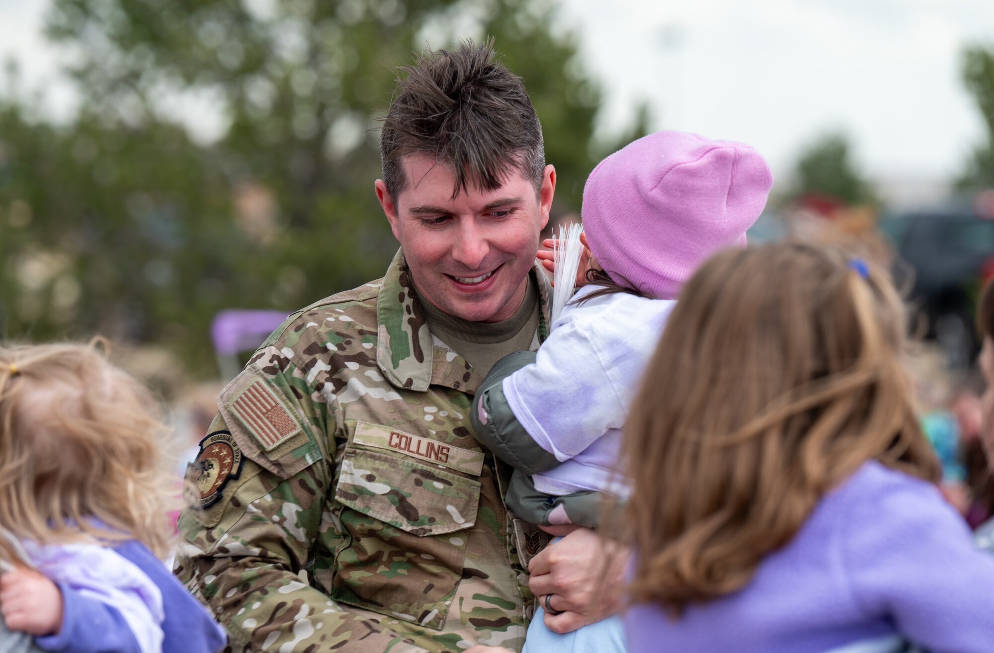 A military father holding his daughter