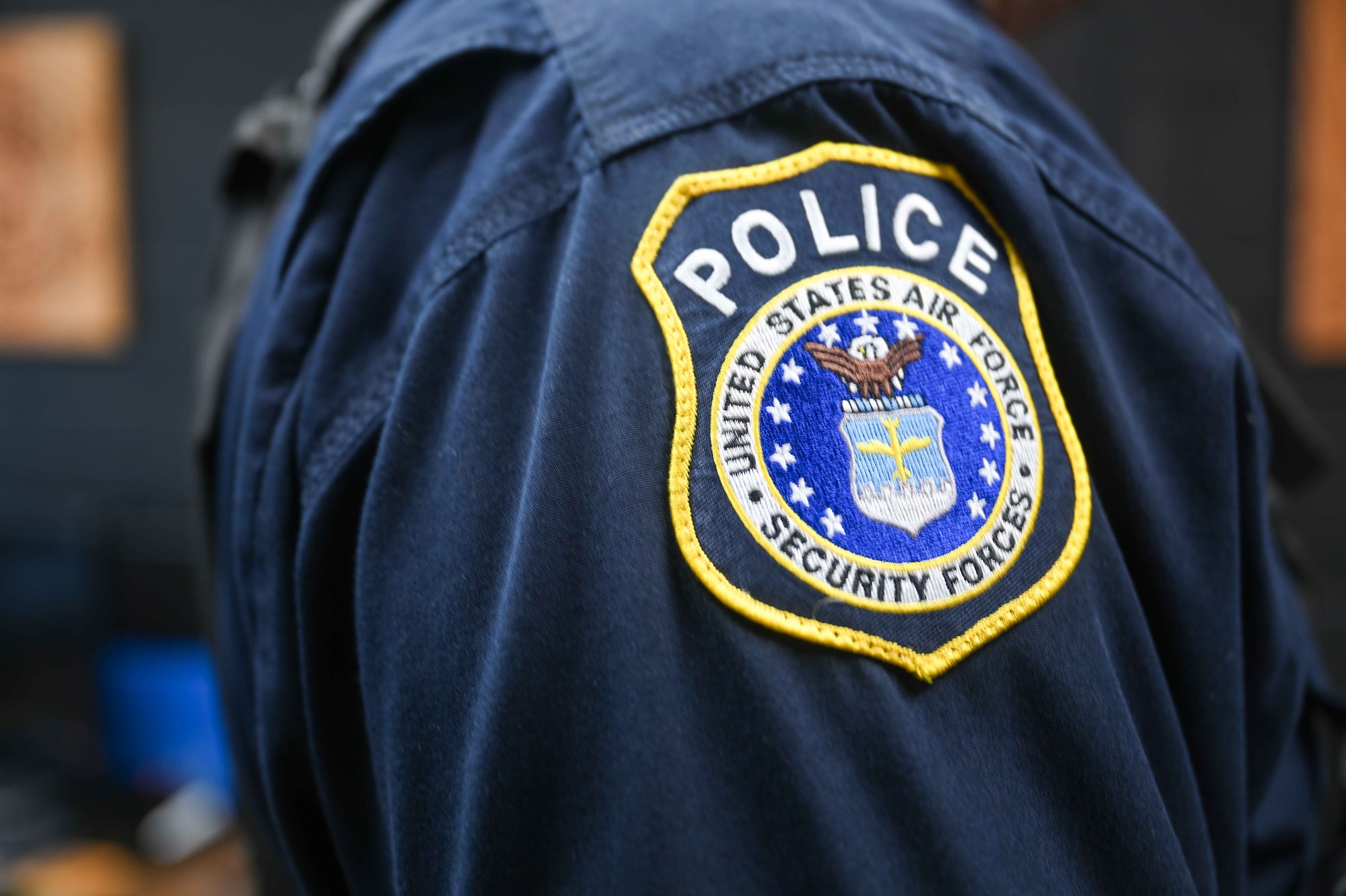 The Department of the Air Force Security Forces logo is sewn onto the jacket of Officer Joseph Holzman, 22nd Security Forces Squadron supervisory police officer, March 31, 2025, at McConnell Air Force Base, Kansas. The Department of the Air Force DAF officers work alongside active-duty U.S. Air Force security forces members to keep the base safe. (U.S. Air Force photo by Senior Airman William Lunn)