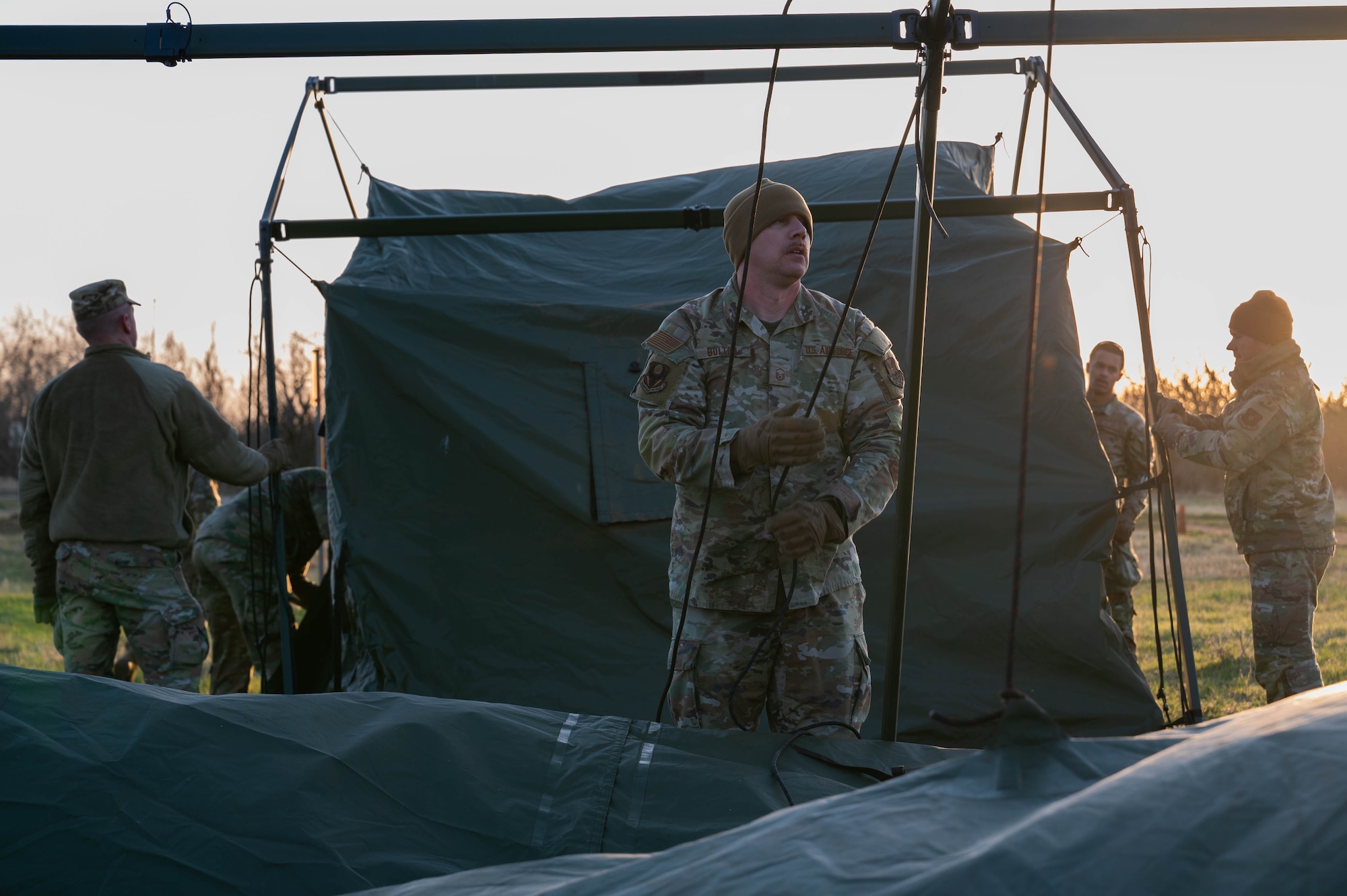 Airmen from the 21st Air Task Force tear down tents during a field training exercise at Dyess Air Force Base, Texas, March 21, 2025. The training was deliberately designed to prepare the 21st ATF to operate effectively in austere environments with limited support. (U.S. Air Force photo by Senior Airman Alondra Cristobal Hernandez)