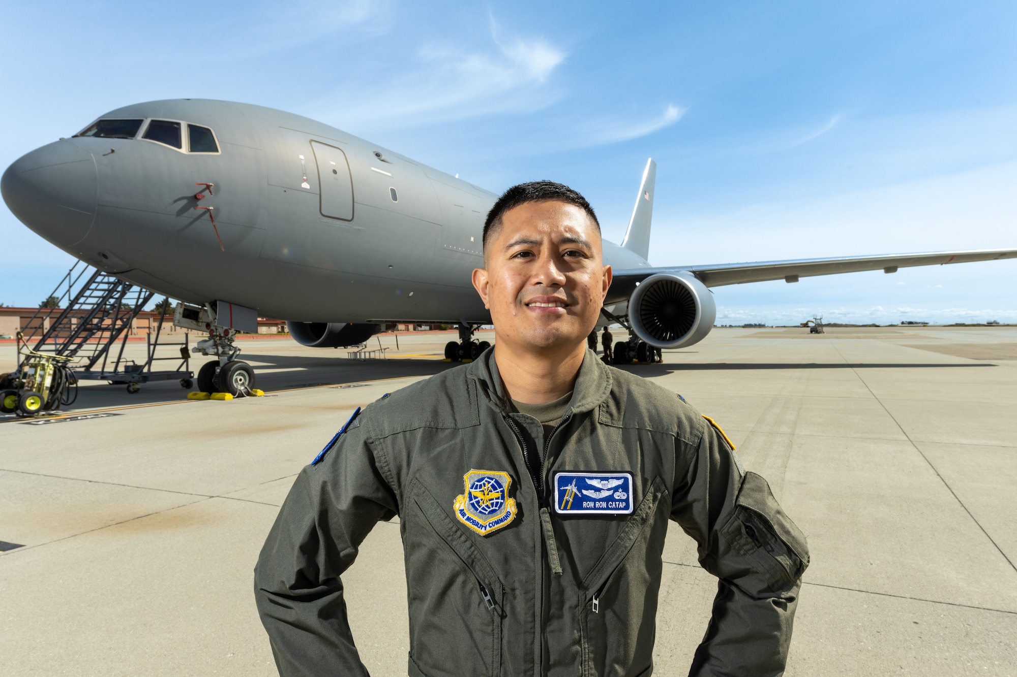 Airman pilot stands in front of KC-46A Pegasus aircraft on the flight line