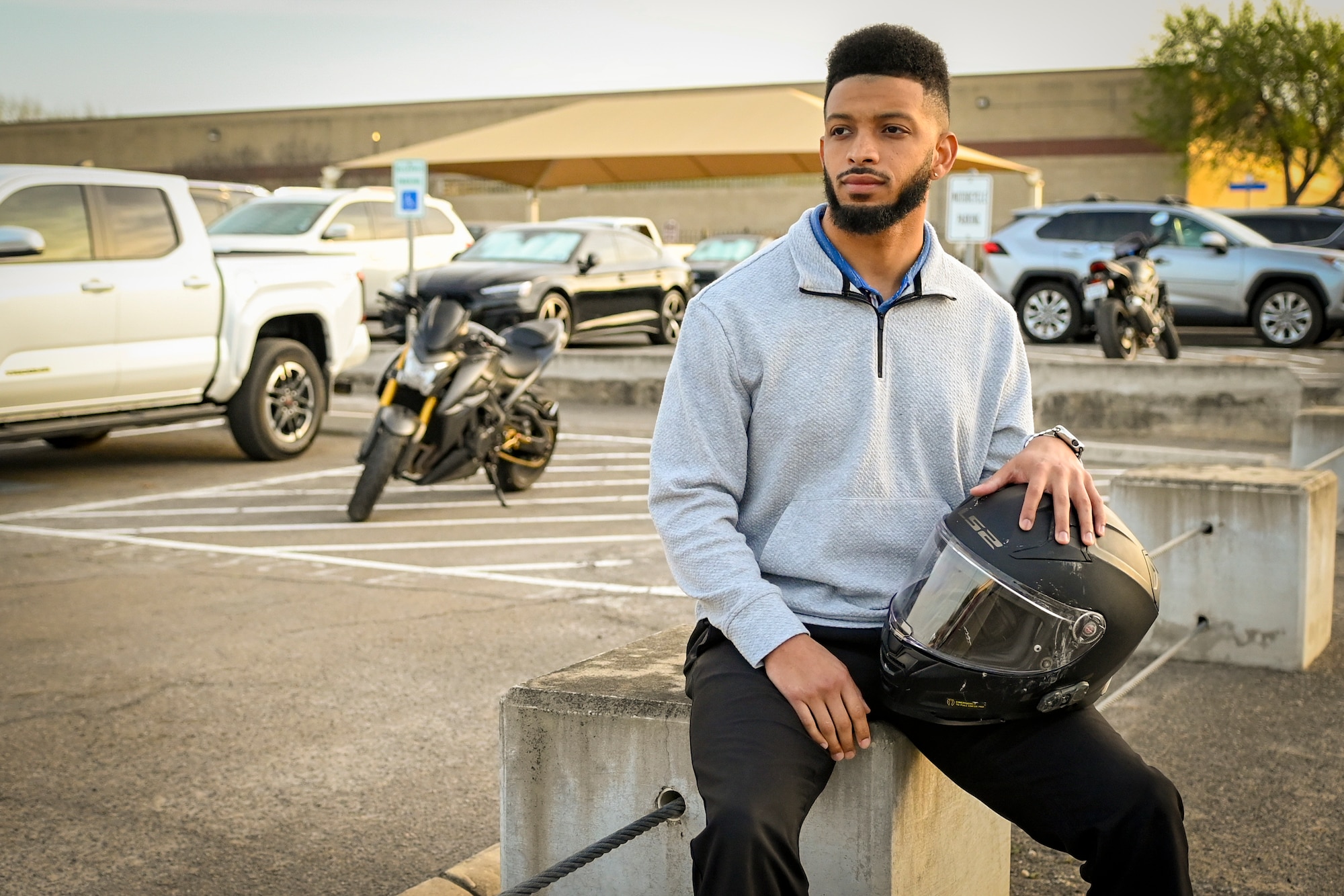 Collin Cox poses with his helmet for a photograph.