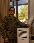 U.S. Marine Corps Sgt. Joshua Joseph R. Camacho, a maintenance management chief with Headquarters Battalion, I Marine Intelligence Group, poses for a photo after installing a portable AC unit in his barracks room at Marine Corps Base Camp Pendleton, Calif., Feb. 21, 2025.