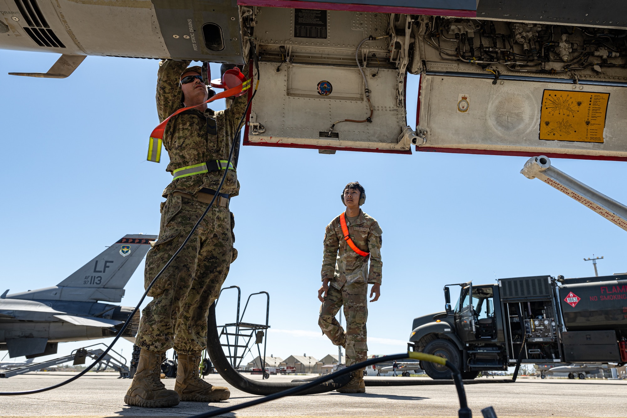 Two members refuel an aircraft