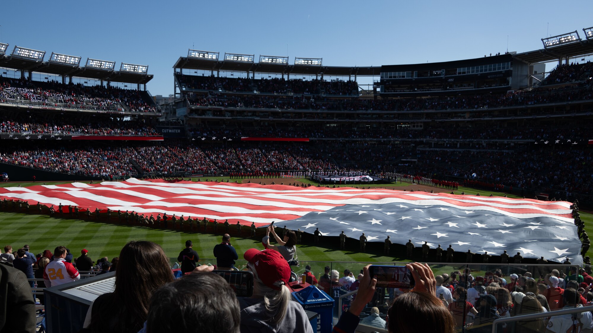 The U.S. flag is unfurled at Nationals Park during Opening Day.