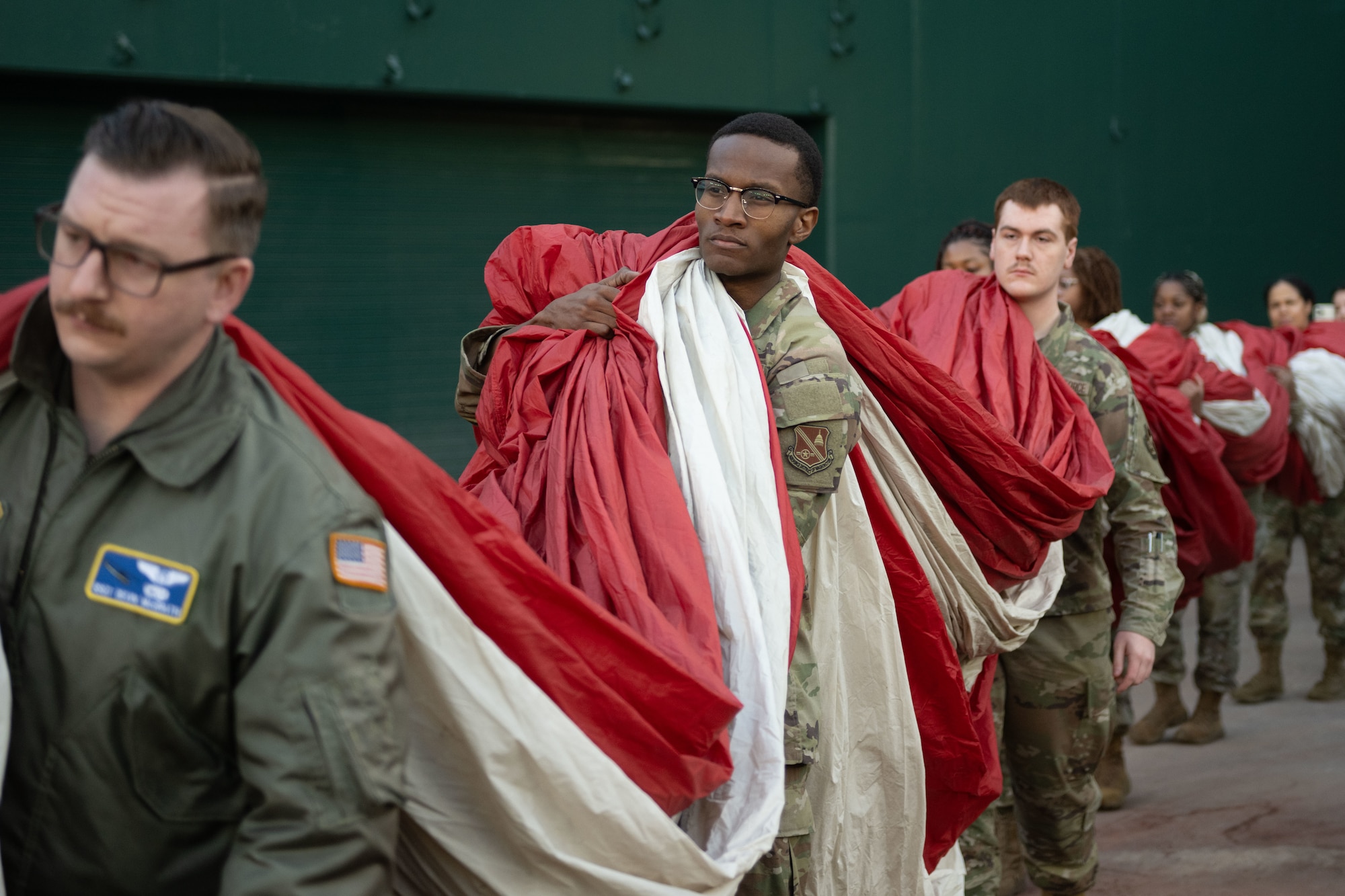 U.S. Airmen carry the U.S. flag onto Nationals Field during Opening Day.
