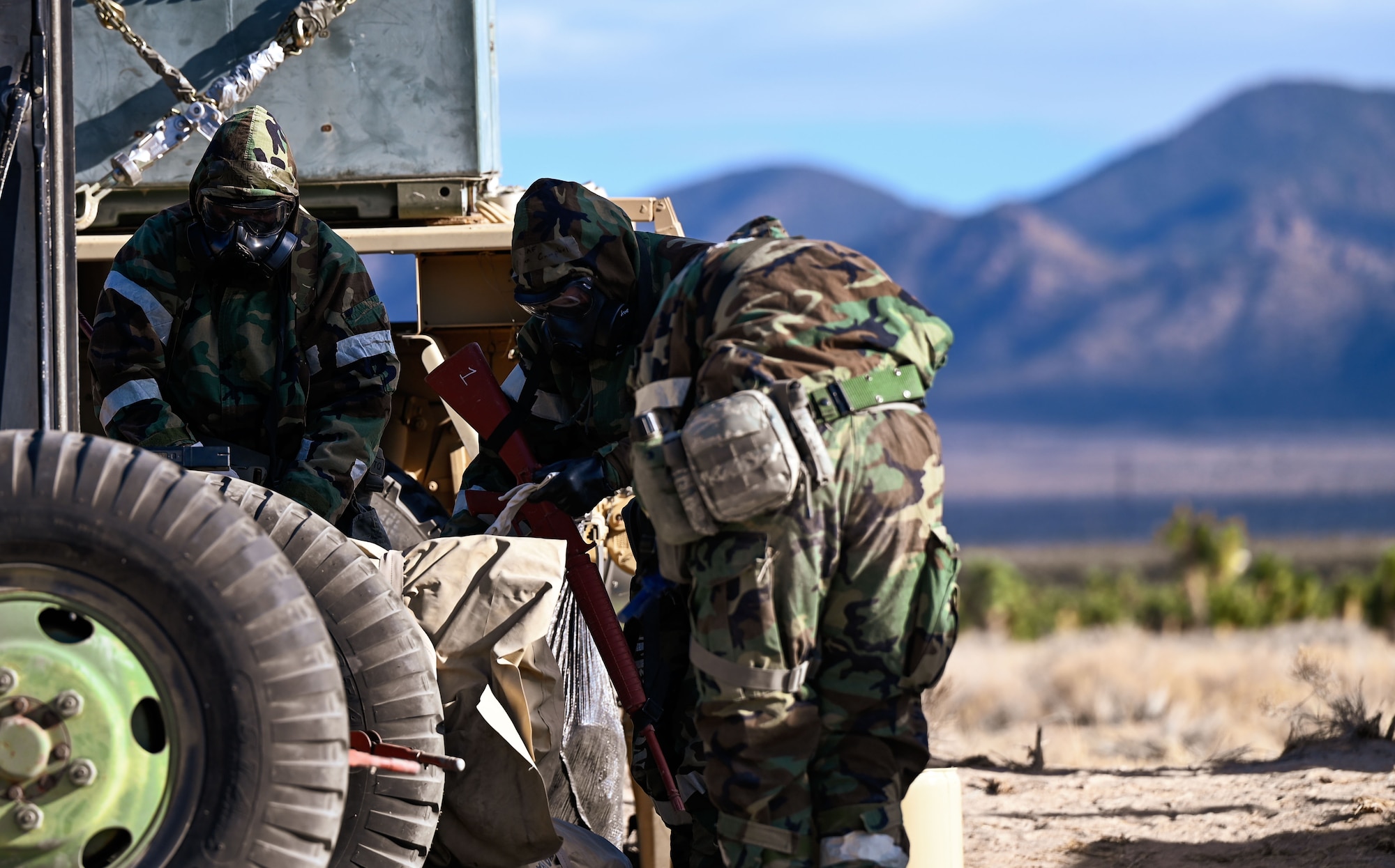 An Airman from the 729th Air Control Squadron adjusts gear in preparation for chemical warfare training. The event was held at the Nevada Test and Training Range, Feb. 4, 2025.
(U.S. Air Force photo by Garrett N. Cole)