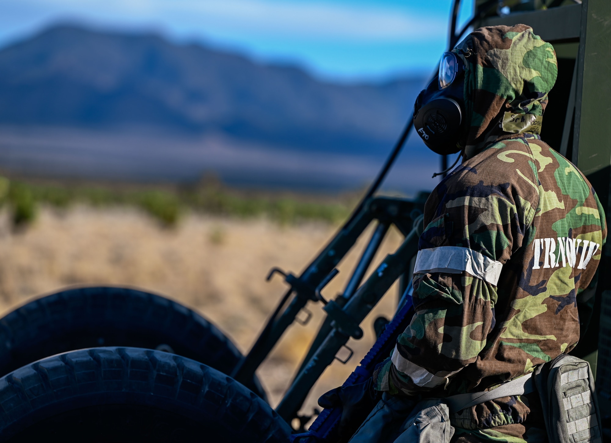 Airmen perform equipment checks while wearing full chemical protective gear during a simulated attack drill. The event occurred at the Nevada Test and Training Range, Feb. 4, 2025.
(U.S. Air Force photo by Garrett N. Cole)