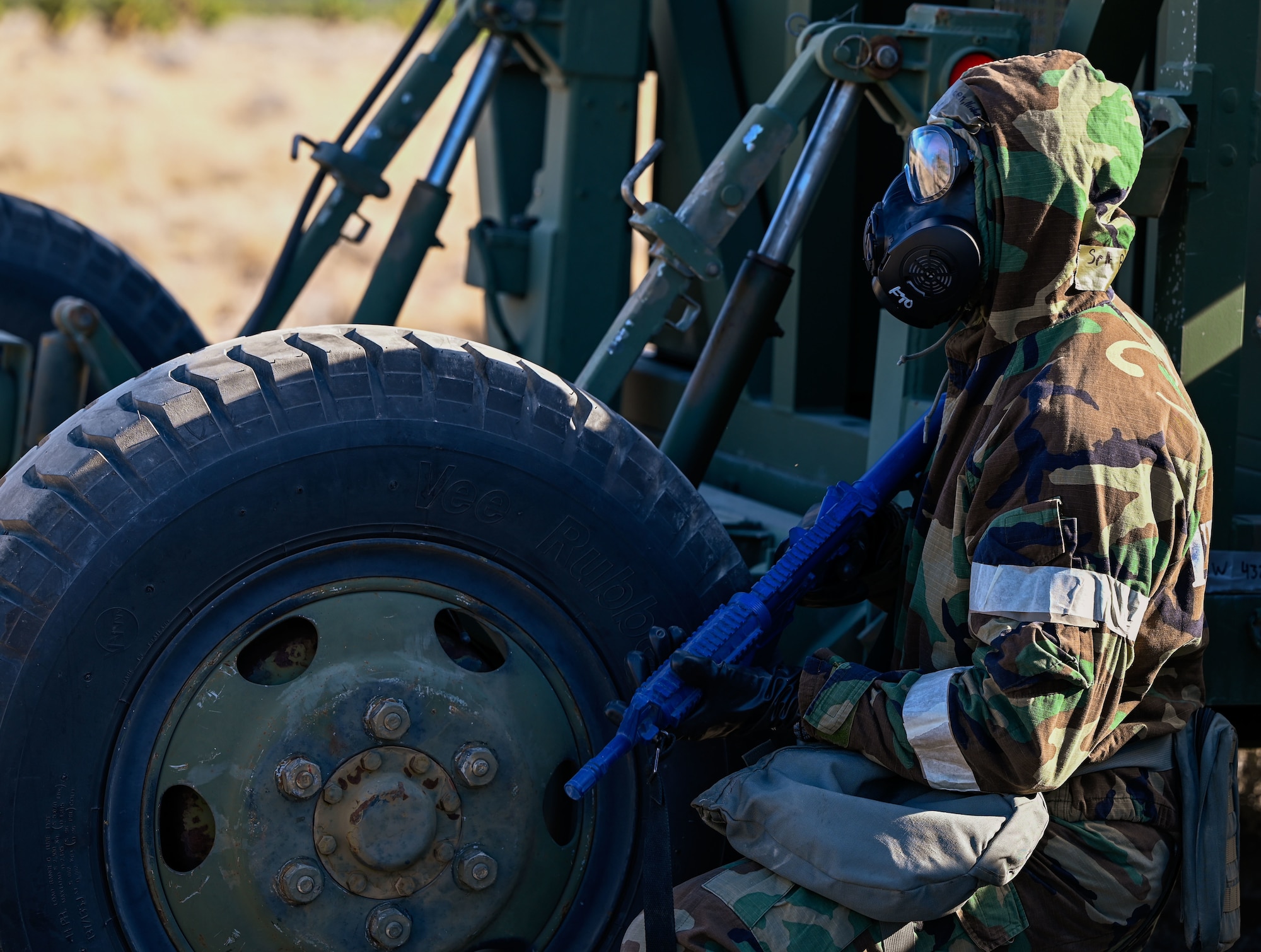 An Airman with the 729th Air Control Squadron scans the area while wearing a gas mask and carrying a blue training weapon. The training was part of Exercise Bamboo Eagle, Feb. 4, 2025.
(U.S. Air Force photo by Garrett N. Cole)