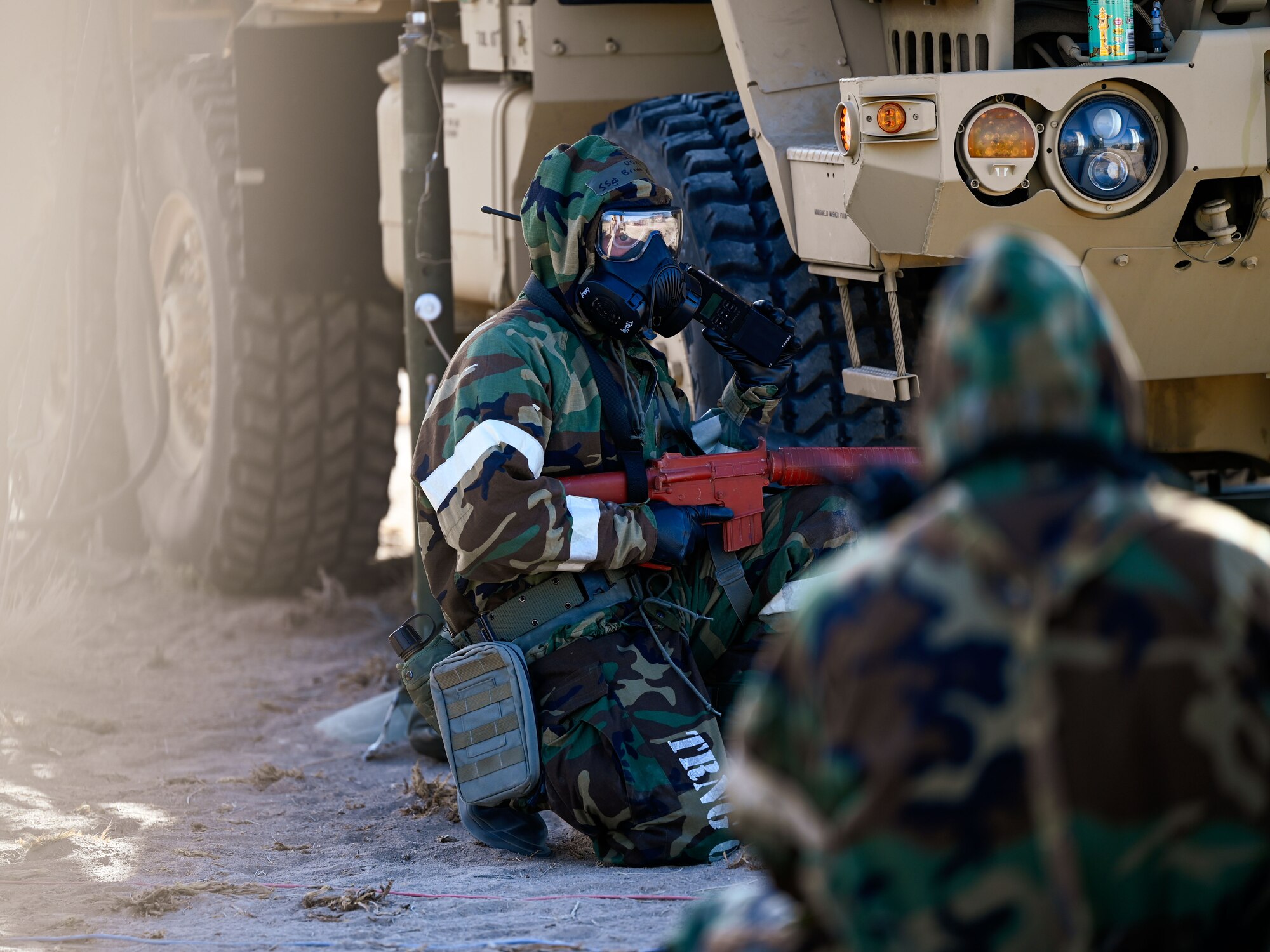 An Airman transmits over radio while holding a red training rifle during a simulated attack drill. The exercise occurred at the Nevada Test and Training Range, Feb. 4, 2025.
(U.S. Air Force photo by Garrett N. Cole)