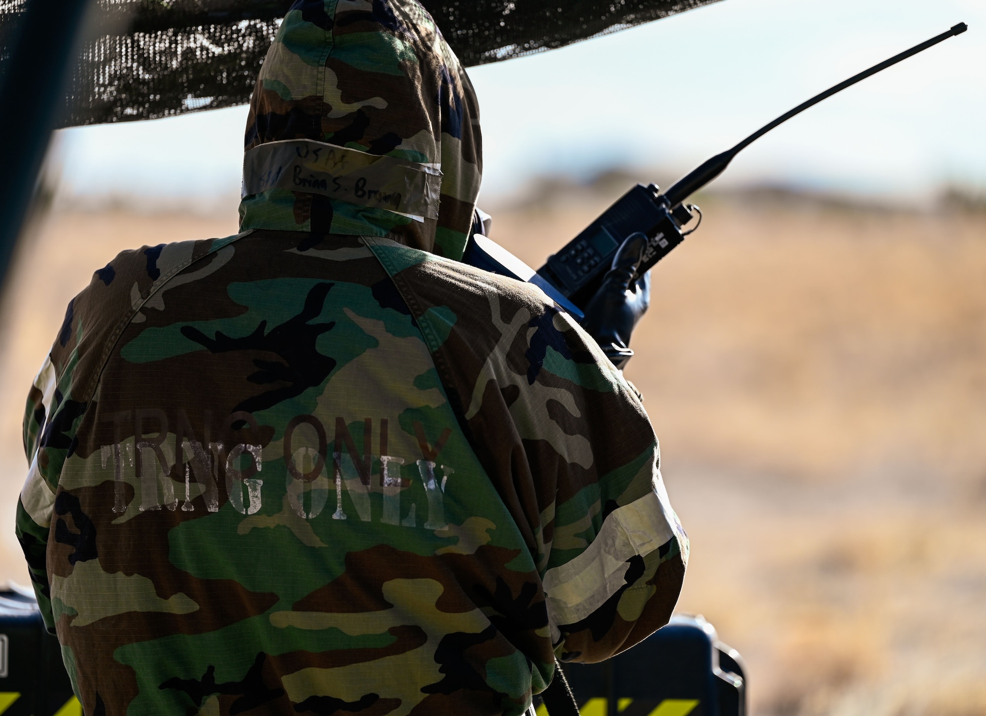 An Airman relays coordinates over radio while participating in a full chemical warfare drill. The scenario unfolded at the Nevada Test and Training Range, Feb. 4, 2025.
(U.S. Air Force photo by Garrett N. Cole)
