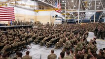 U.S. Air Force Gen. Thomas Bussiere coins Airmen in front of a crowd during an all-call.