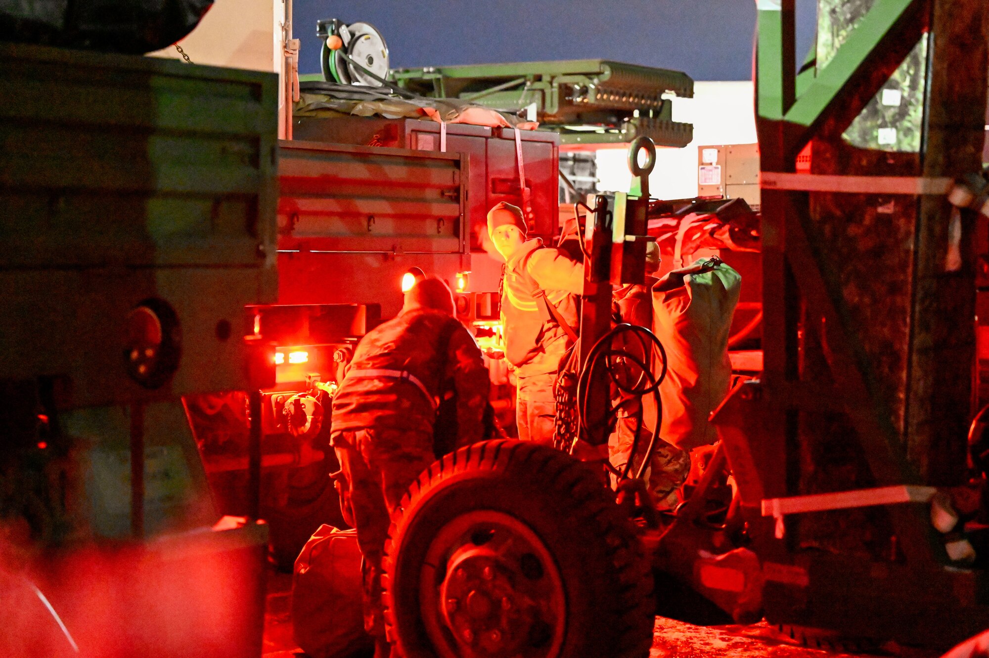 Airmen load gear and inspect trailers under red lighting before departure during Exercise Bamboo Eagle at Hill Air Force Base, Utah, Jan. 9, 2025. Night operations are a critical element of large-scale deployment training.
(U.S. Air Force photo by Garrett N. Cole)
