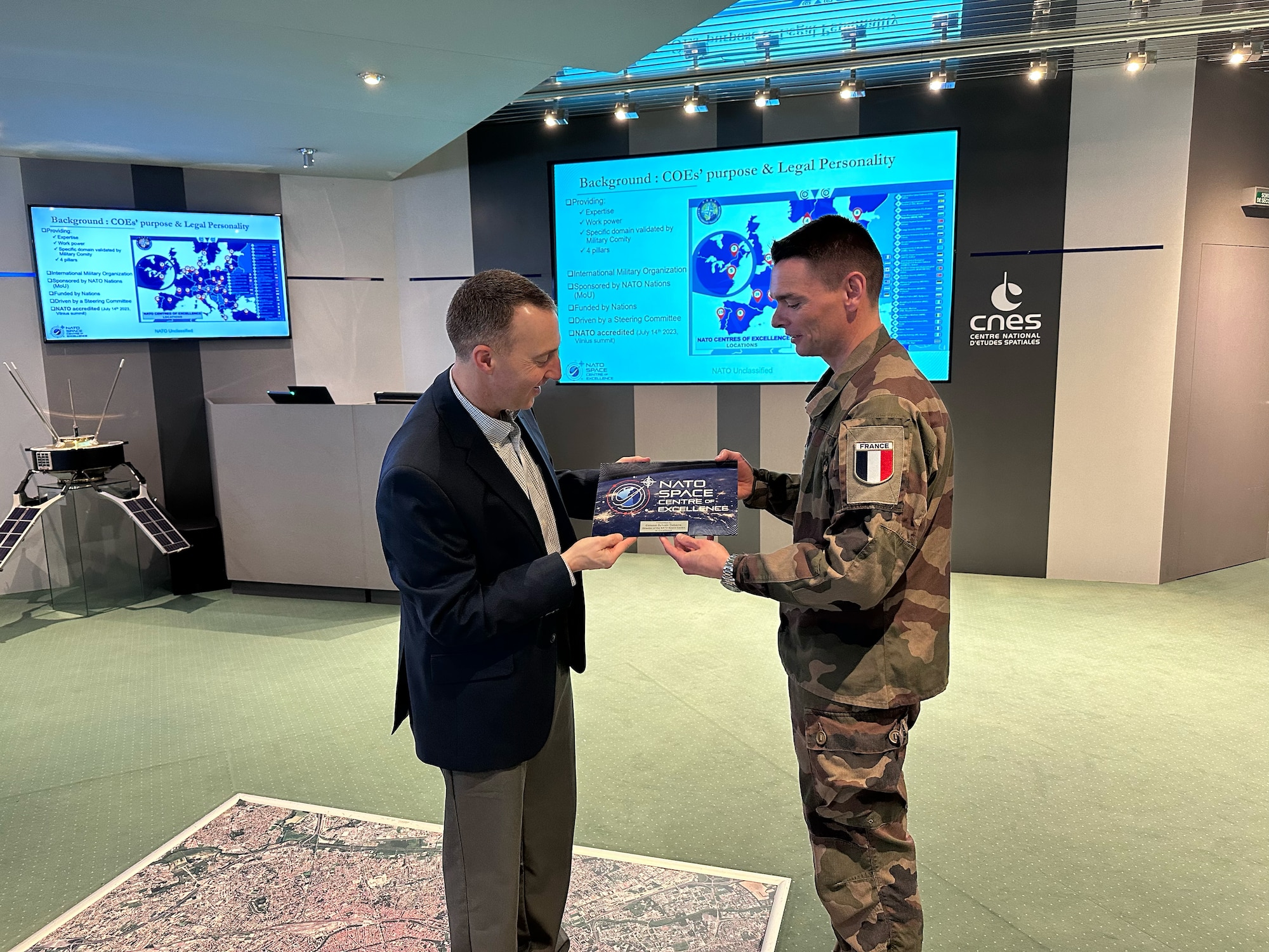 U.S. Space Force Brig. Gen. Matthew Cantore, deputy commander of Space Training and Readiness Command, accepts a gift from the NATO Space Centre of Excellence during his visit in Toulouse, France, March 28, 2025.