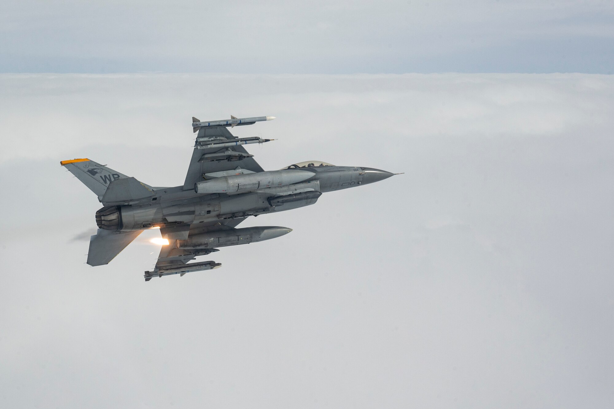 An F-16 Fighting Falcon aircraft assigned to the 80th Fighter Squadron releases flares while flying over the Korean Peninsula.