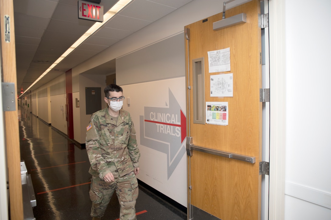 man walks down a hallway