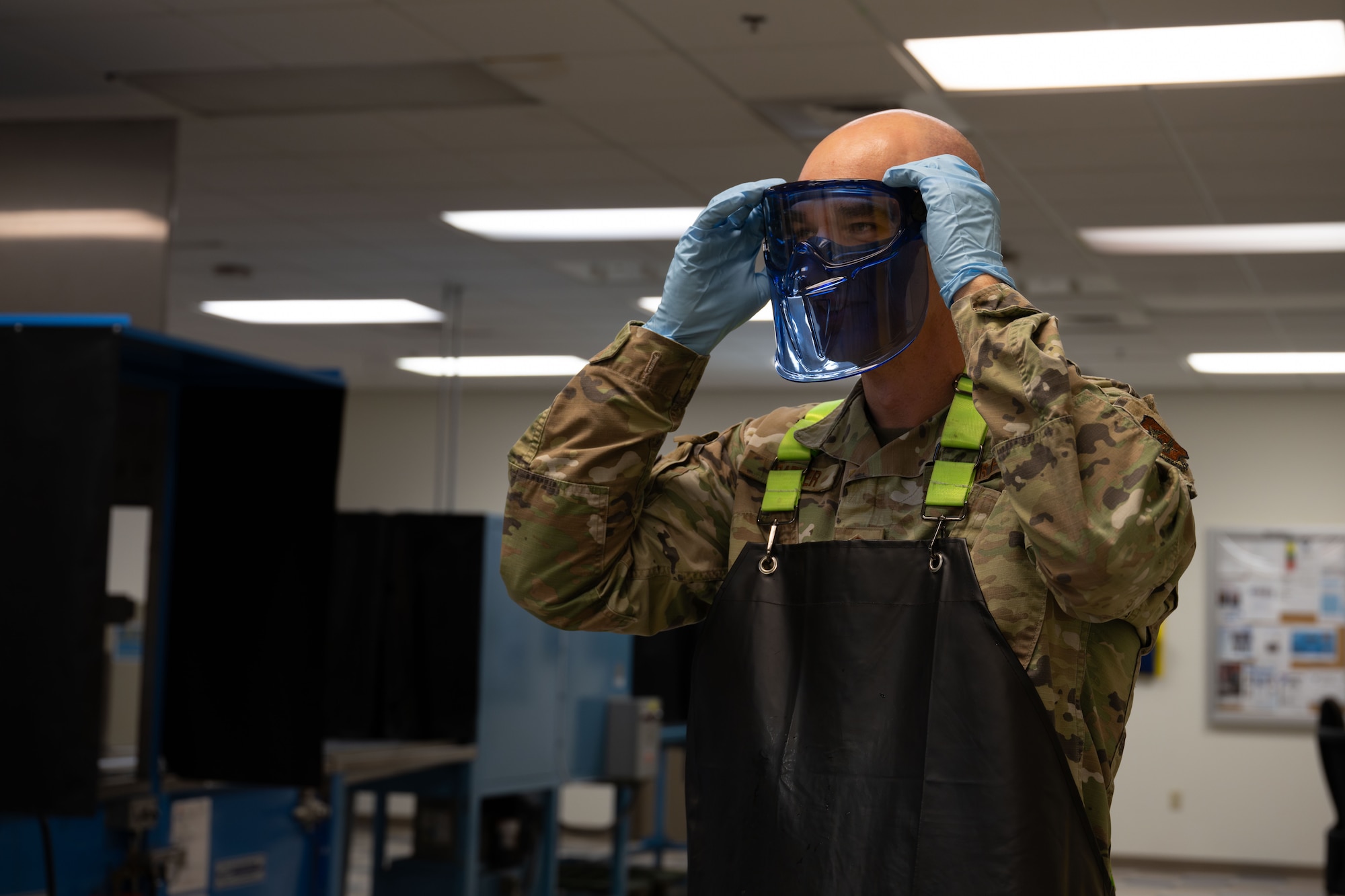 Master Sgt. Jason Barker, 931st Maintenance Squadron nondestructive inspection section chief, puts on safety equipment April 1, 2025, at McConnell Air Force Base, Kansas. NDI specialists play a role in ensuring the safety of equipment, ultimately protecting the lives of pilots and crew members. (U.S. Air Force photo by Airman 1st Class Paula Arce)