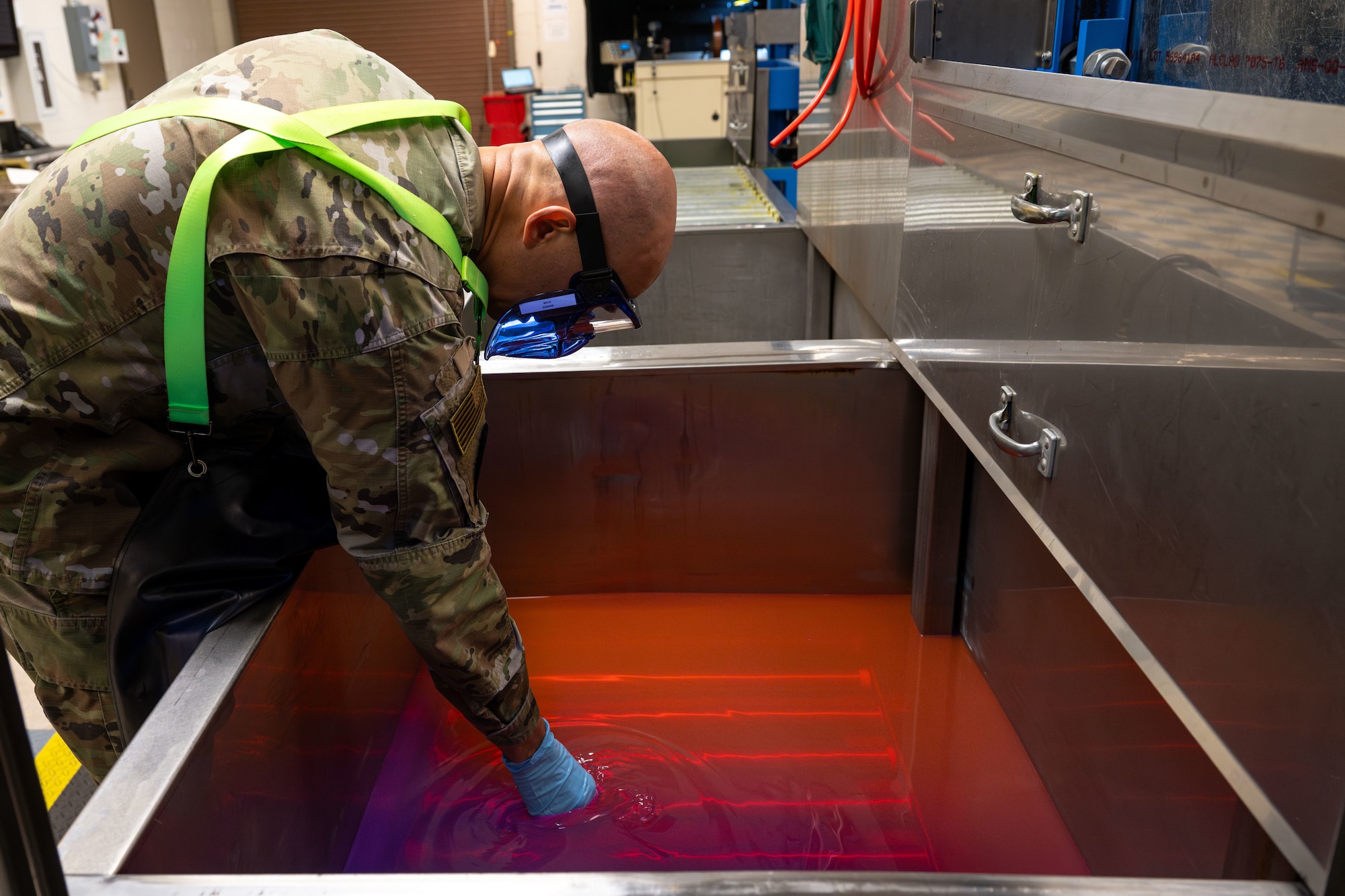 Master Sgt. Jason Barker, 931st Maintenance Squadron nondestructive inspection section chief, dips a KC-135 Stratotanker part into a hydrophilic emulsifier April 1, 2025, at McConnell Air Force Base, Kansas. NDI specialists use the penetrant liquid inspection method to detect defects in small aircraft parts, ensuring the parts’ structural integrity and ultimately protecting the lives of pilots and air crew. (U.S. Air Force photo by Airman 1st Class Paula Arce)