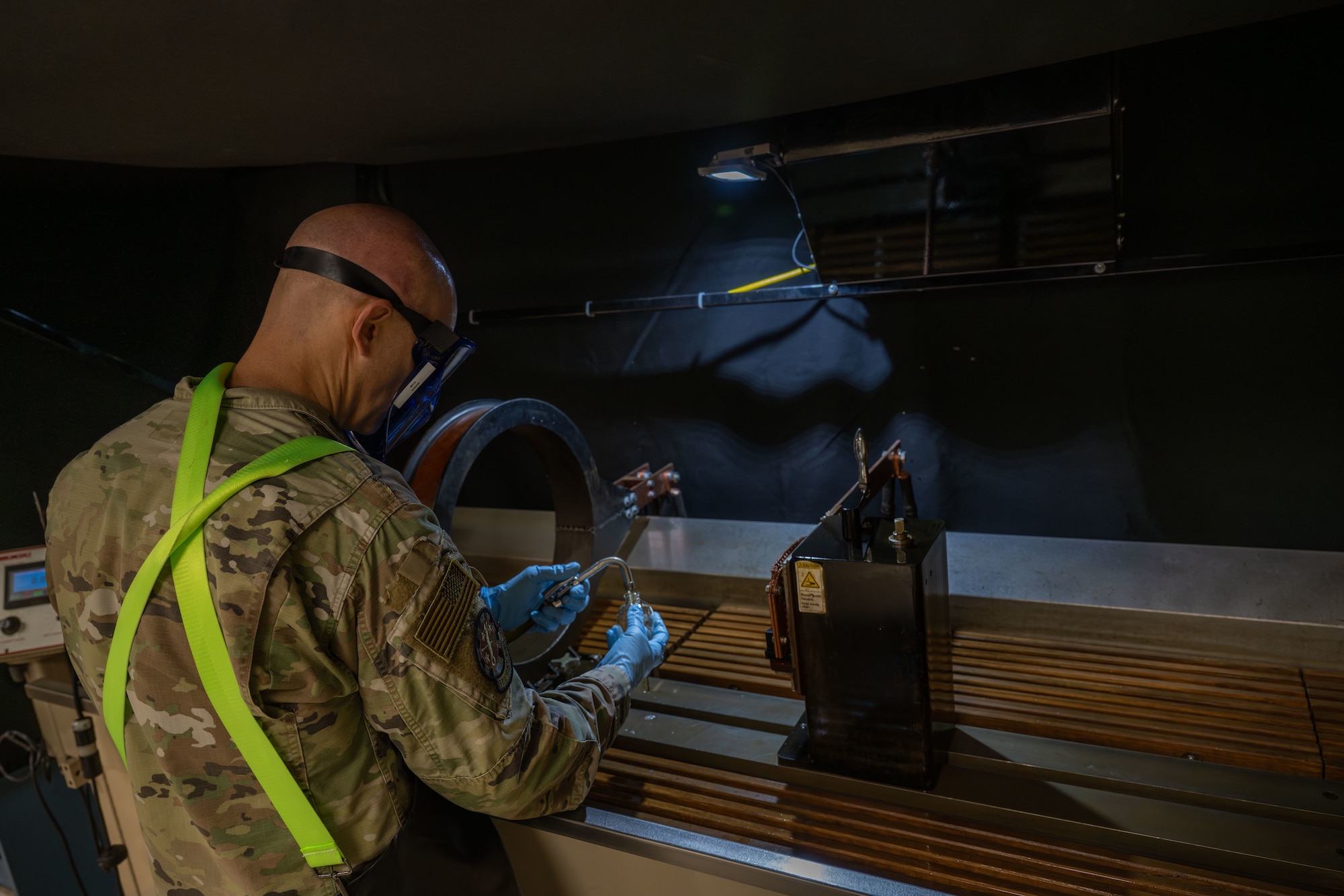 Master Sgt. Jason Barker, 931st Maintenance Squadron nondestructive inspection section chief, fills a centrifuge tube with particle inspection liquid April 1, 2025, at McConnell Air Force Base, Kansas. NDI specialists view the centrifuge tube under an ultraviolet light to check parts for defects. (U.S. Air Force photo by Airman 1st Class Paula Arce)