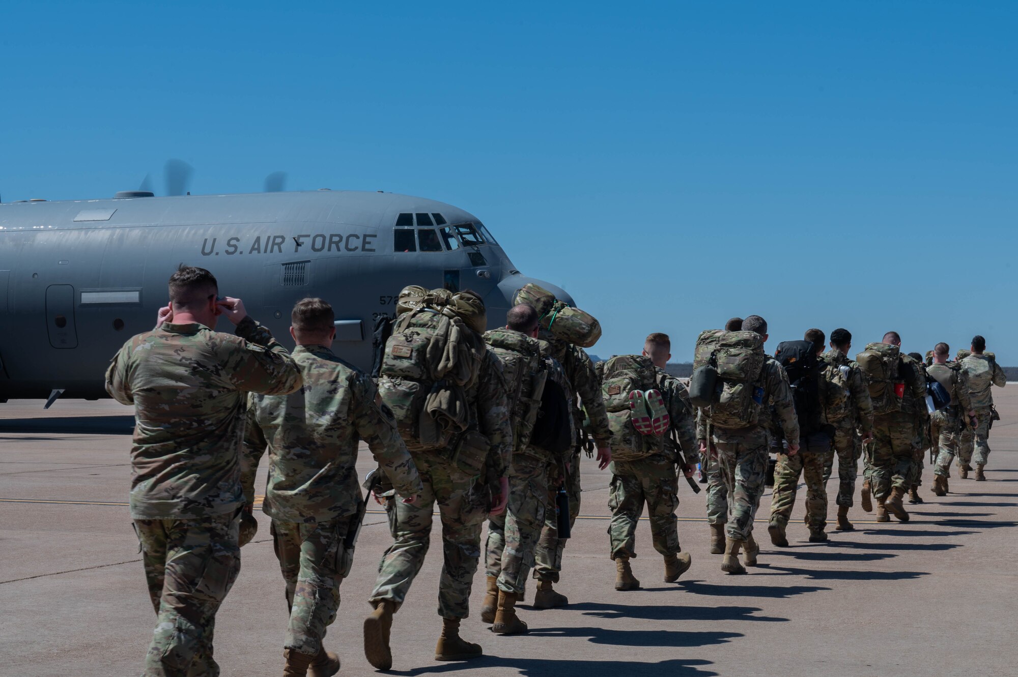 Airmen from the 21st Air Task Force prepare to board a C-130J Super Hercules assigned to the 317th Airlift Wing during a field training exercise at Dyess Air Force Base, Texas, March 20, 2025. The 21st ATF and 317th AW leveraged their local partnership to tackle converging priorities. The exercise started with a flight provided by the 317th AW, simulating flying into an austere environment to create a more realistic training scenario. (U.S. Air Force photo by Senior Airman Alondra Cristobal Hernandez)