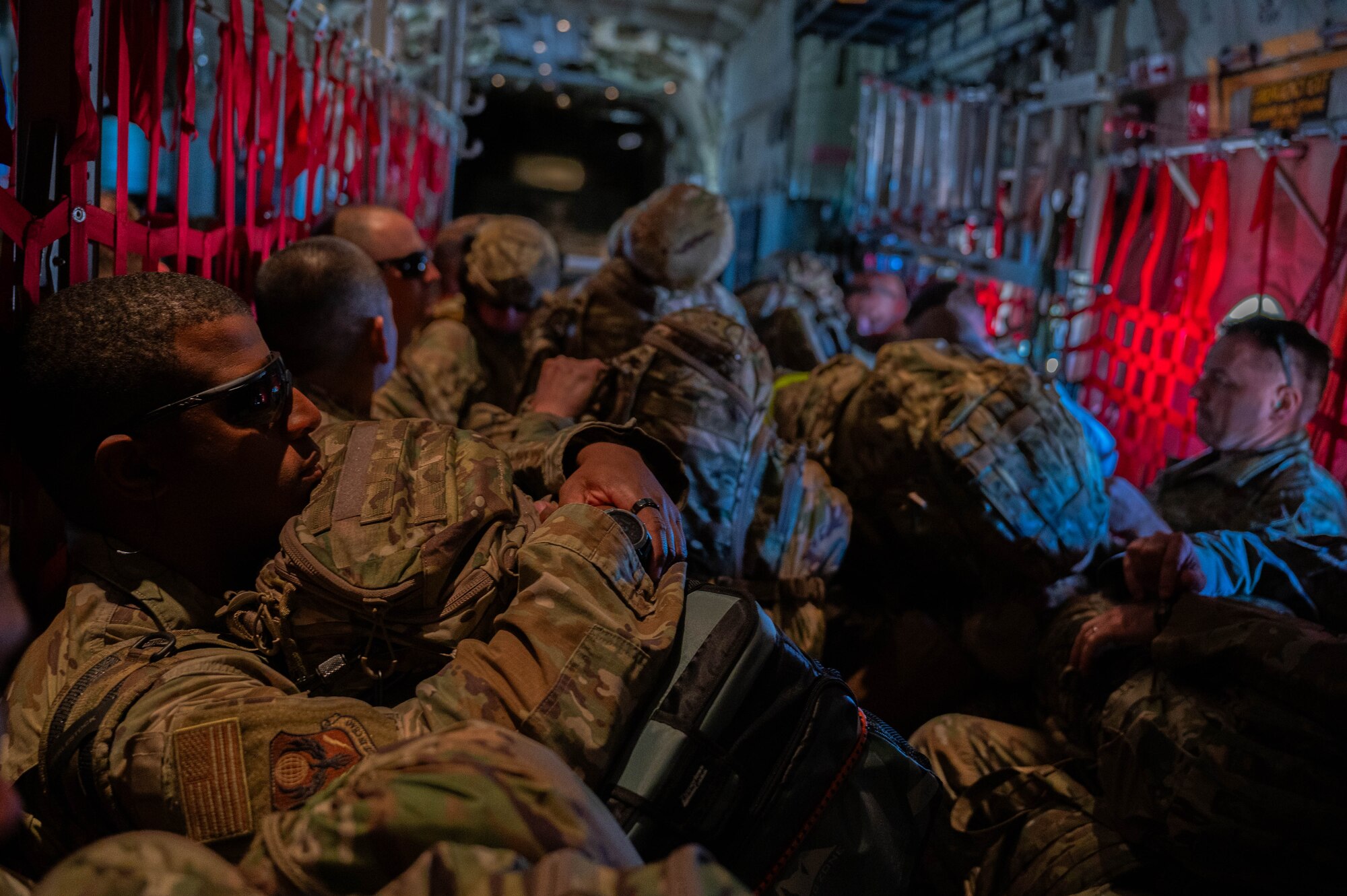 Airmen from the 21st Air Task Force await takeoff in a C-130J Super Hercules assigned to the 317th Airlift Wing during a field training exercise at Dyess Air Force Base, Texas, March 20, 2025. The 21st ATF and 317th AW leveraged their local partnership to tackle converging priorities, yielding more proficient war-fighting teams for both organizations. (U.S. Air Force photo by Senior Airman Alondra Cristobal Hernandez)