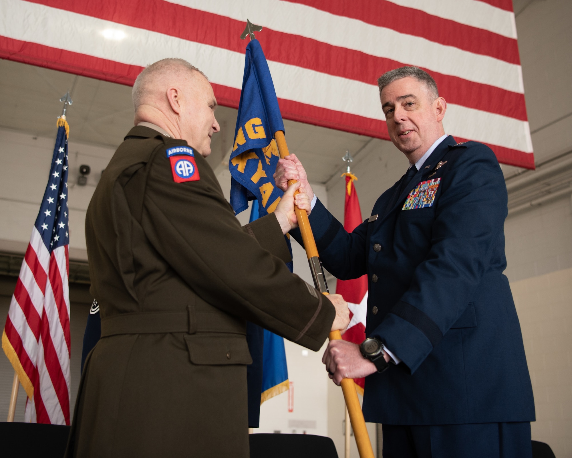 U.S. Air Force Brig. Gen. Bruce Bancroft, right, Kentucky’s new assistant adjutant general for Air, takes command of the Kentucky Air National Guard by accepting the organization’s guidon from U.S. Army Maj. Gen. Haldane Lamberton, adjutant general of the Commonwealth of Kentucky, during a ceremony at the Kentucky Air National Guard Base in Louisville, Ky., March 14, 2025. Bancroft, a former commander of Kentucky’s 123rd Airlift Wing, is replacing U.S. Air Force Brig. Gen. David Mounkes, who is retiring from military service after a 35-year career in the active-duty Air Force and Air National Guard.  (U.S. Air National Guard photo by Master Sgt. Joshua Horton)