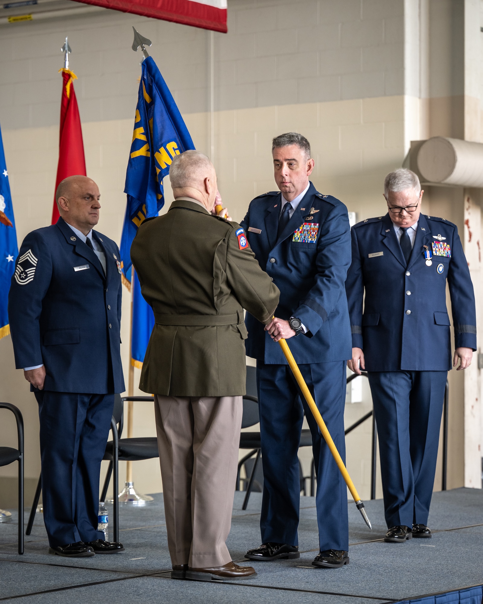 U.S. Air Force Brig. Gen. Bruce Bancroft, right, Kentucky’s new assistant adjutant general for Air, takes command of the Kentucky Air National Guard by accepting the organization’s guidon from U.S. Army Maj. Gen. Haldane Lamberton, adjutant general of the Commonwealth of Kentucky, during a ceremony at the Kentucky Air National Guard Base in Louisville, Ky., March 14, 2025. Bancroft, a former commander of Kentucky’s 123rd Airlift Wing, is replacing U.S. Air Force Brig. Gen. David Mounkes, who is retiring from military service after a 35-year career in the active-duty Air Force and Air National Guard.  (U.S. Air National Guard photo by Dale Greer)