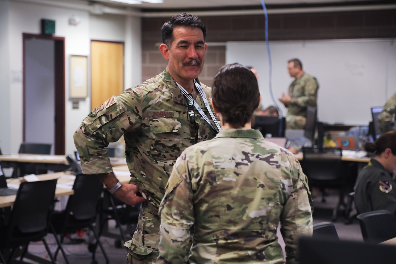Col. Matthew Komatsu, director of Plans and Strategy for the Joint Staff, Alaska National Guard, discusses the role of Women, Peace, and Security during mission planning with Maj. Chelsea Aspelund, State Partnership Program director, Alaska National Guard, at Joint Base Elmendorf-Richardson, Alaska, March 6, 2025.