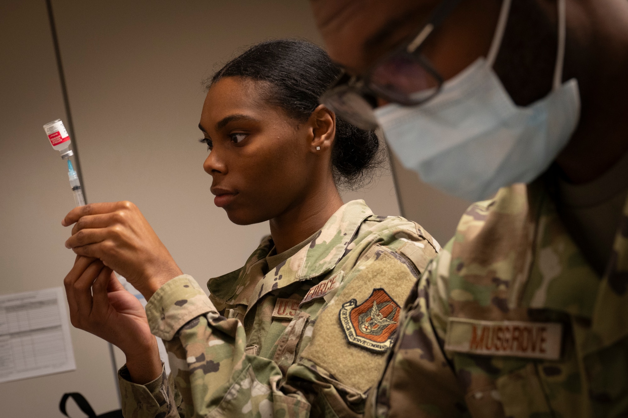 a man and woman prepare vaccines