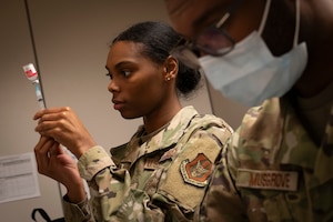 a man and woman prepare vaccines
