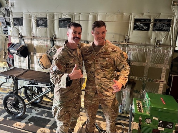 Image of two Airmen posing for a photo.