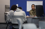 Senior Airman Trina Quirindongo, a recruiter for the 113th Wing, District of Columbia Air National Guard and the reigning Ms. District of Columbia, guides an 18-year-old recruit through the enlistment process at the D.C. Air National Guard storefront recruitment office in Brandywine, Md., on March 17, 2025. Quirindongo uses her pageant platform, “Power Over Trauma,” to promote resilience and confidence while serving as an ambassador and mentor for future Air National Guard members.