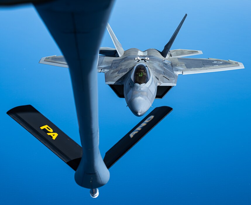 KC-135 Stratotanker provides fuel for an F-22 Raptor