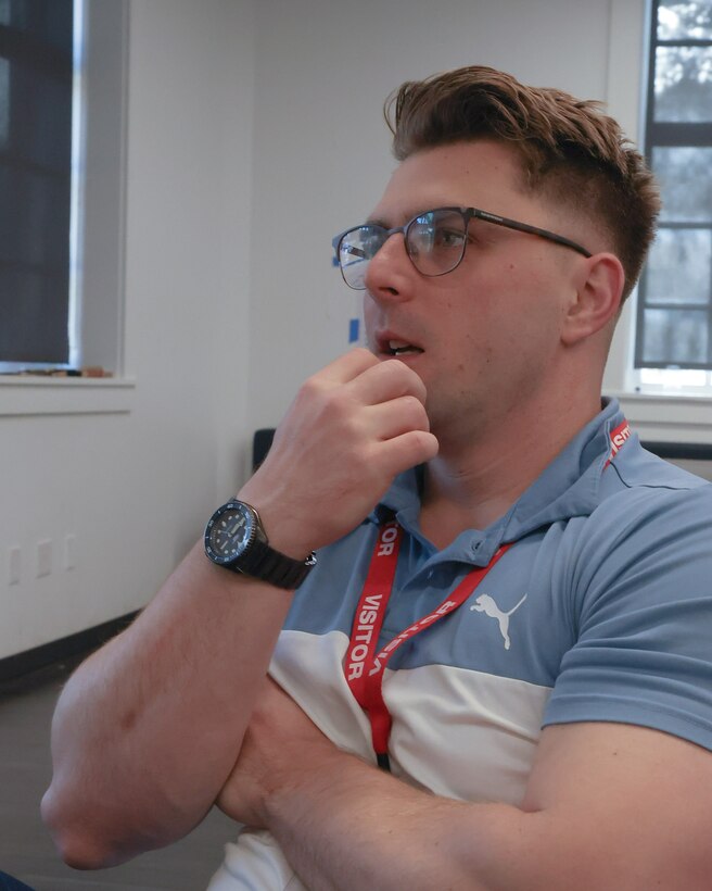 U.S. Marine Corps Captain Alexander J. Beal, a data systems specialist with Marine Corps Tactical Systems Support Activity (MCTSSA), reviews code for the Augmented Reconnaissance and Estimate of the Situation (ARES) software application at the Marine Corps Software Factory (MCSWF), 21 March, 2025.  MIU Marines are assisting MCSWF in the development and production of software solutions that address critical needs for the Marine Corps, including an update to ARES that predicts helicopter landing zones based on topographical data. Beal assists MCSWF and the Marine Innovation Unit with developing software, leveraging his studies at Naval Postgraduate School and his work with MCTSSA. (U.S. Marine Corps photo by Cpl. Orion Stpierre)
