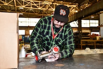Norfolk Naval Shipyard’s Pipefitter Shop (Shop 56) Pipefitter Mechanic Patrick Douglas has been at the shipyard for almost two years. His short-term goal is to become qualified to take over the operation of the acid room used for component cleaning.