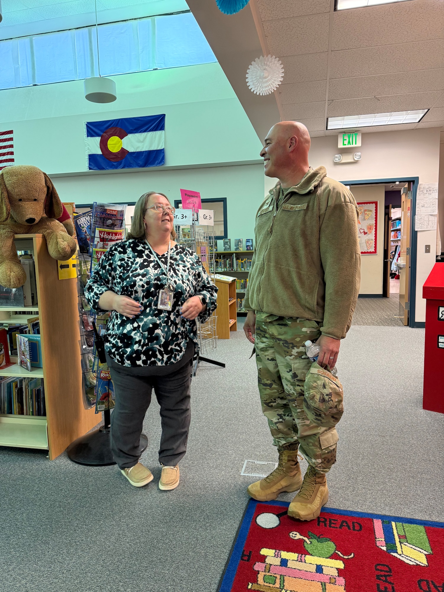 Michele Matte, District 22’s Ellicott Elementary School principal, and U.S. Air Force Col. David Berrios, Space Base Delta 1 deputy commander, visit the library during a tour of the school in Ellicott, Colorado, March 25, 2025.