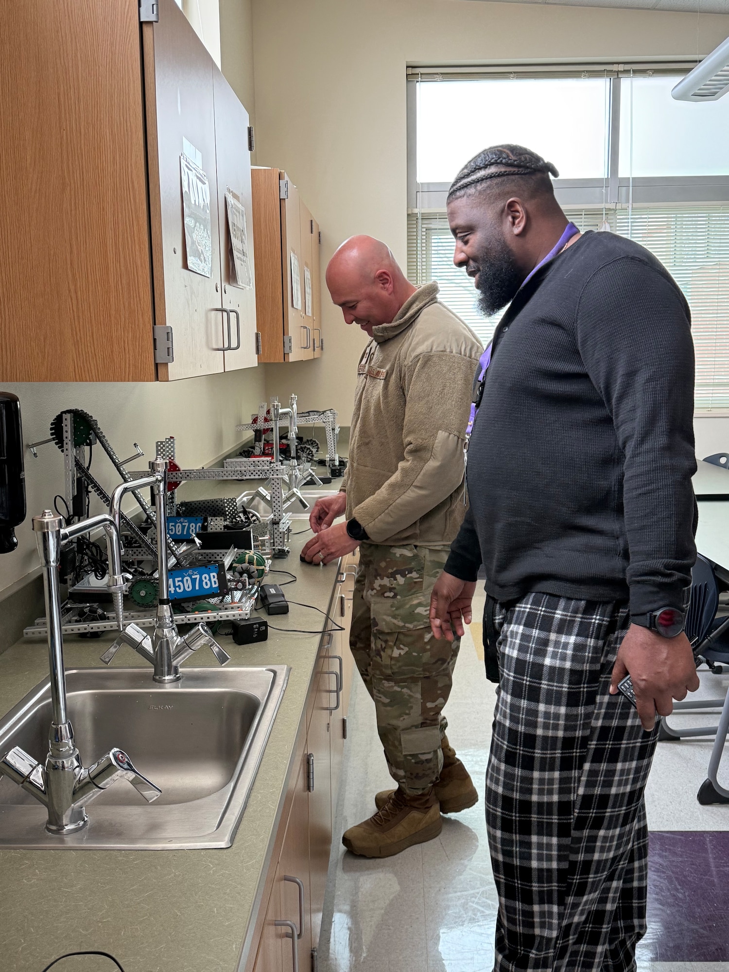 U.S. Air Force Col. David Berrios, Space Base Delta 1 deputy commander, and Donte Stewart, Ellicott School District 22 Ellicott Middle School principal, view the robotics lab while on a tour of Ellicott Middle School in Ellicott, Colorado, March 31,