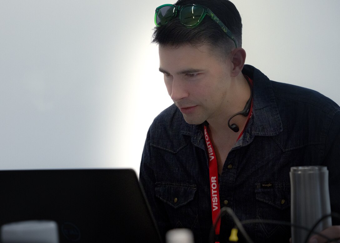 U.S. Marine Corps Maj. Ryan Hennessey, assigned to the Marine Innovation Unit (MIU), Marine Forces Reserve, works on a “Flight Mode” software feature at the Marine Corps Software Factory (MCSWF) in Austin, Texas, 17 - 29 March, 2025. MIU Marines are assisting MCSWF in the development and production of software solutions that address critical needs for the Marine Corps, including Flight Mode, an interface that makes it easier for pilots to receive and record digital information in flight. MIU is a Selected Marine Corps Reserve unit headquartered in Newburgh, N.Y. that accelerates the development and adoption of advanced capabilities across the Marine Corps. (U.S. Marine Corps photo by Cpl. Orion Stpierre)
