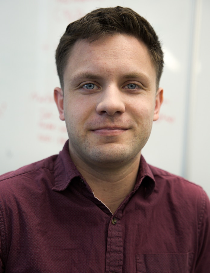 U.S. Marine Corps Cpl. Connor Oaks, assigned to the Marine Innovation Unit (MIU), Marine Forces Reserve, poses for a photo at the Marine Corps Software Factory (MCSWF), 21 March, 2025. Oaks analyzes data and writes code for software applications being developed by Marines with MIU and MCSWF. Oaks is a Miluwakee Wisconsin native. (U.S. Marine Corps photo by Cpl. Orion Stpierre)