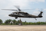 U.S. Army Joint Task Force-Bravo Headquarters Support Company Soldiers hook up cargo containing construction material to a HH-60 Blackhawk during PANAMAX-Alpha Phase 0 in Panama, March 29, 2025.