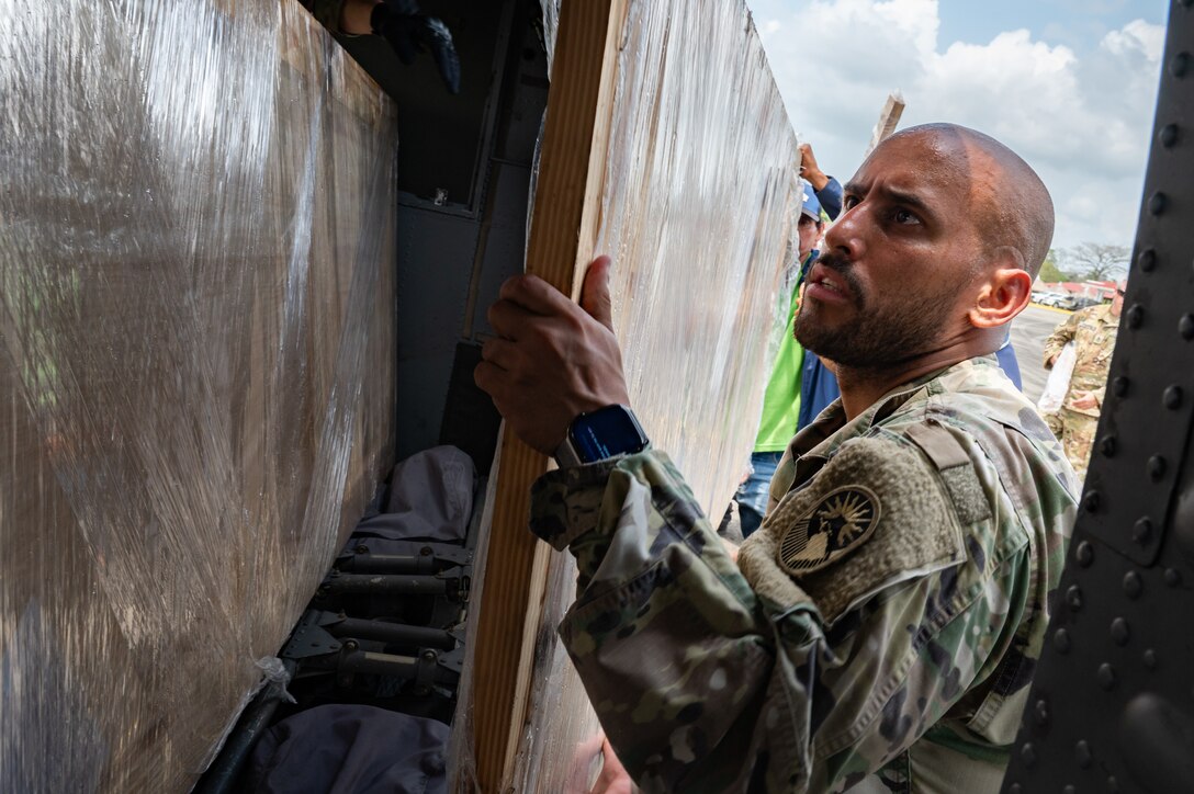 U.S. Army Sgt. Brian Vazquez, Joint Task Force-Bravo Headquarters Support Company sling load inspector, loads construction material into a HH-60 Blackhawk during PANAMAX-Alpha Phase 0 in Panama, March 29, 2025.