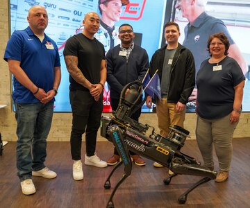 Air Force Captain Capt Joseph Brown, Master Sergeant Nicholas Chung, Airman 1st Class Brandon Marshall, 1st Lt. Michael Ressler, and Irma Blancas from the 688th Cyberspace Wing pose for a group photo at MotoUp's "AI At The Edge" contest.