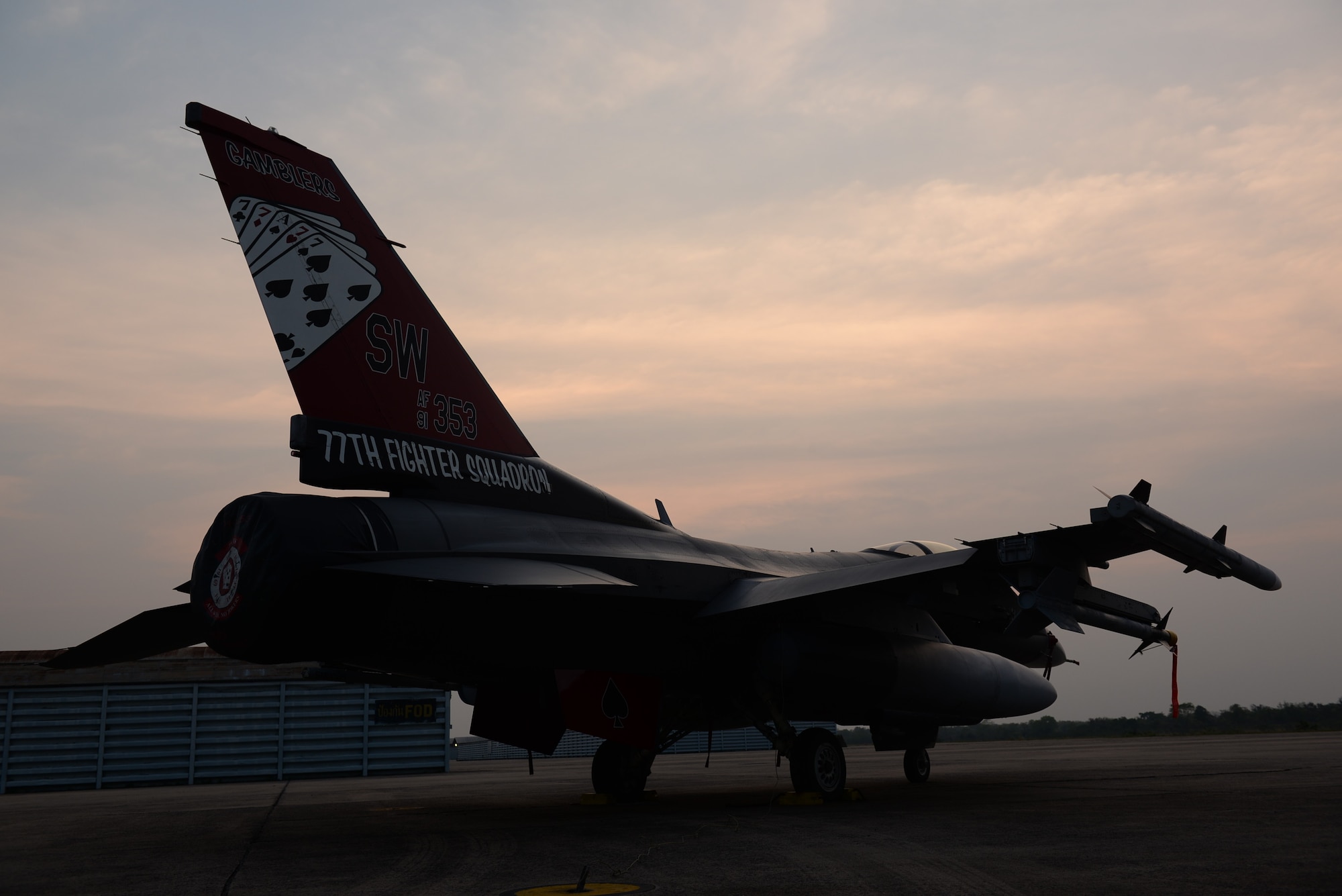 A fighter jet sits on a concrete pad