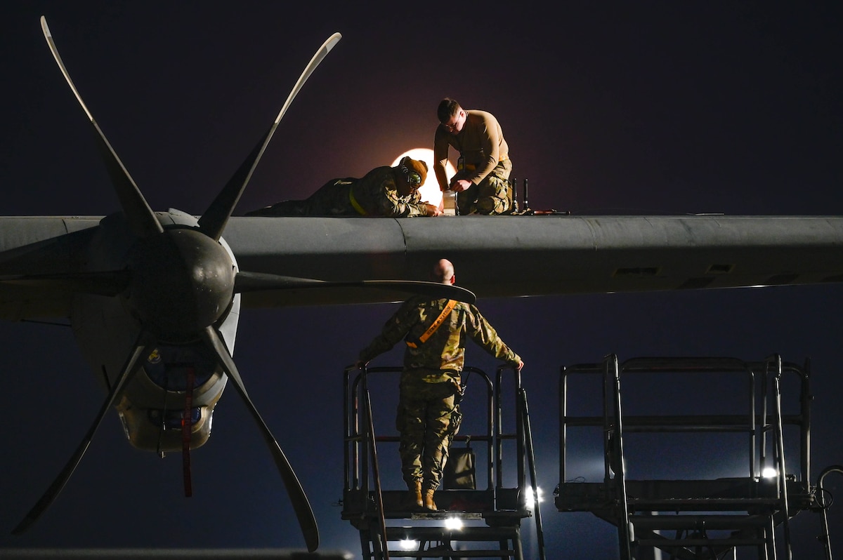 Team Little Rock Airmen perform maintenance on a C-130J Super Hercules while a Hunter's Moon rises over Little Rock Air Force Base, Arkansas, Oct. 17, 2024. The installation continuously enhances its capabilities through cutting-edge training programs, strategic partnerships and modernization efforts to ensure it remains at the forefront of tactical airlift operations.