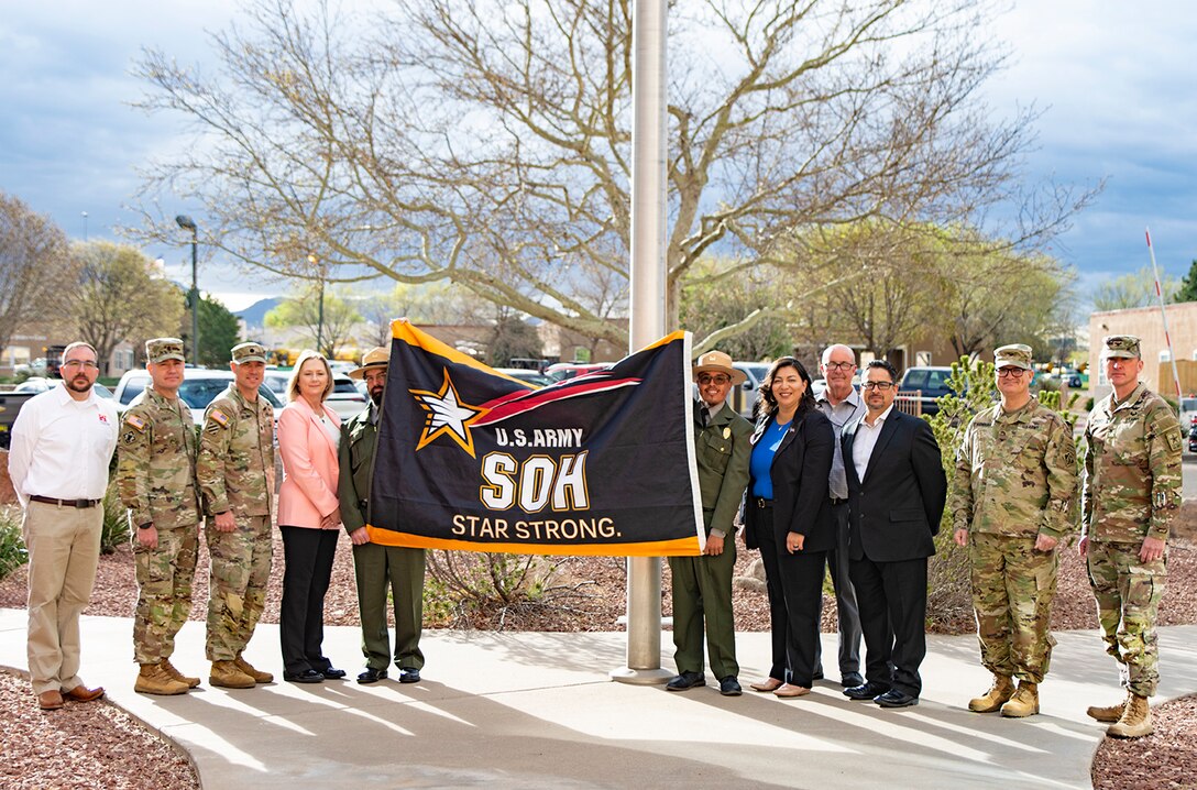 (l-r): Jacob Pauley, deputy district engineer, Albuquerque District; USACE Command Sgt. Maj. Douglas Galick; Lt. Col. Matthew Miller, commander, Albuquerque District; Tracy Wolf, chief, Safety Office, Albuquerque District; Ben Massey, lead ranger, Cochiti Lake, Albuquerque District; Wayne Arquero, park ranger, Cochiti Lake, Albuquerque District; Lucy Pillera, safety and occupational health specialist, Albuquerque District; Derrick Dunlap, chief, Operations Branch, Albuquerque District; Anthony Cardona safety and occupational health specialist, Albuquerque District; Col. James Handura, commander, USACE-South Pacific Division; and Col. Matthew Parker, deputy commander, Army Combat Readiness Center stand with the Army Safety and Occupational Health Star flag right before it is flown over the Albuquerque District’s headquarters, April 1, 2025.