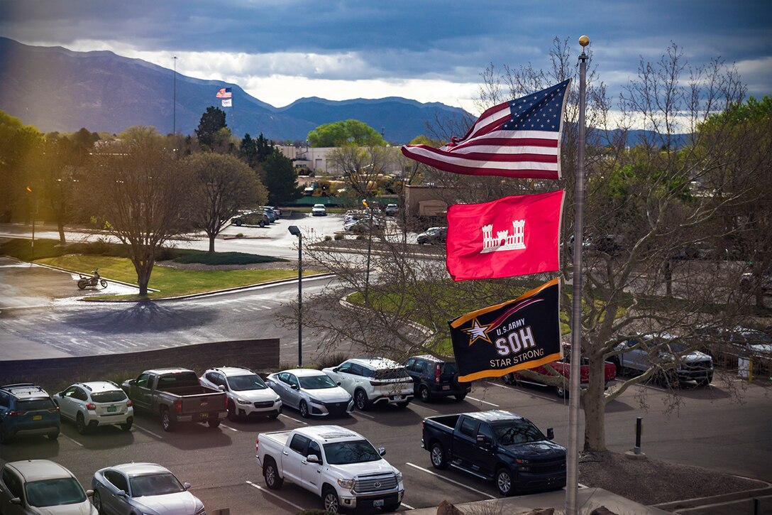 The Army Safety and Occupational Health Star flag flies under the American and USACE flags in front of the Albuquerque District headquarters, April 1, 2025. The flag was formally presented to the Albuquerque District during a ceremony earlier in the day.