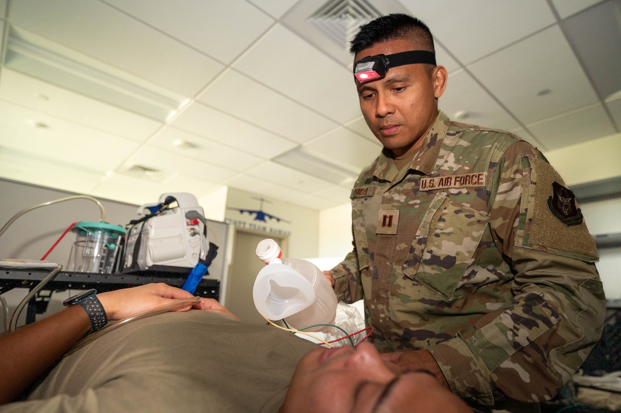 Capt. Jason Pureza, a member of the 624th Aeromedical Staging Squadron, Critical Care Air Transport Team, demonstrates treatment techniques he used while on call in his civilian capacity during a Unit Training Assembly at Joint Base Pearl Harbor-Hickam, Hawaii, on Jan. 11, 2025.