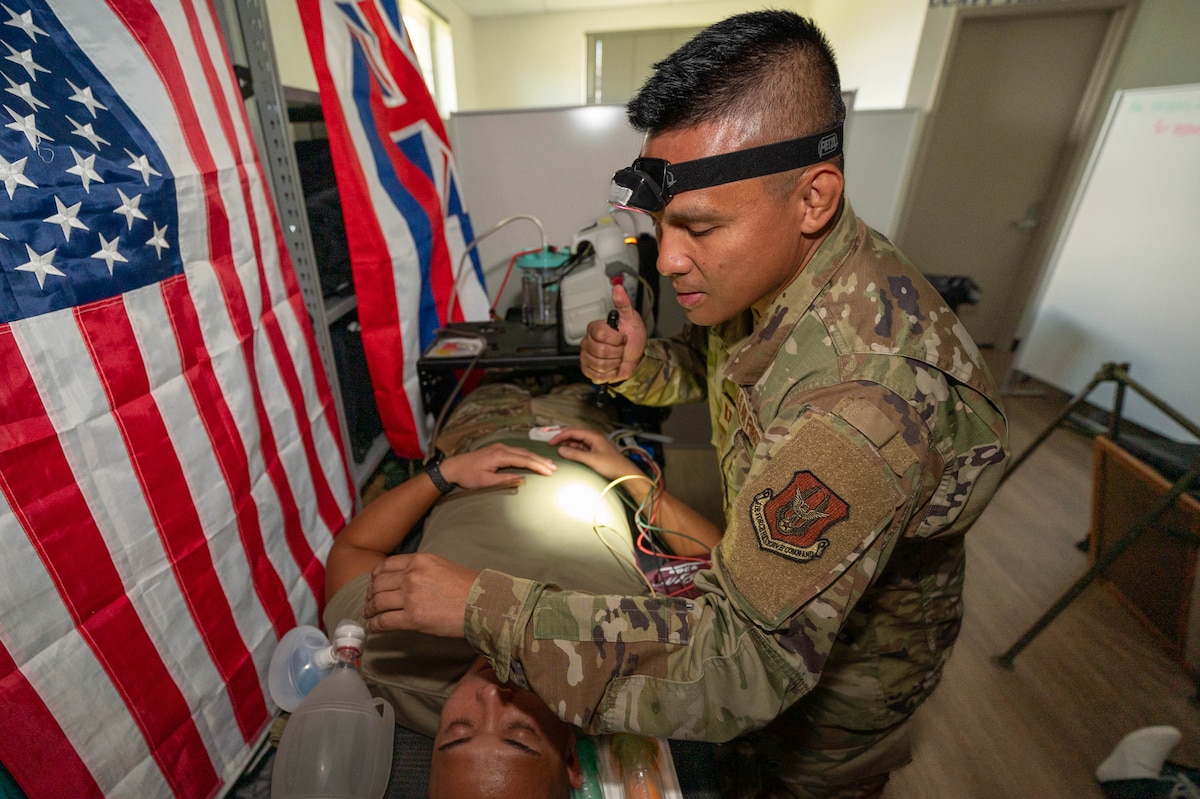 Capt. Jason Pureza, a member of the 624th Aeromedical Staging Squadron, Critical Care Air Transport Team, demonstrates treatment techniques he used while on call in his civilian capacity during a Unit Training Assembly at Joint Base Pearl Harbor-Hickam, Hawaii, on Jan. 11, 2025.