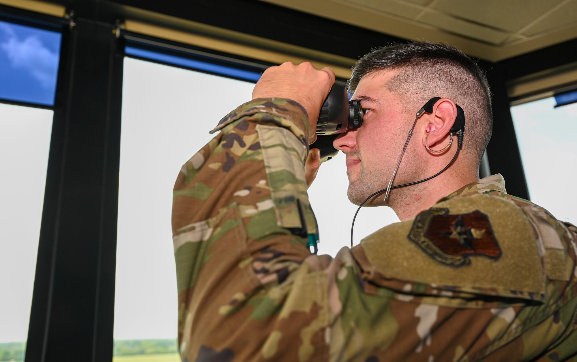U.S. Air Force Senior Airman Logan Jarrett, 42nd Operations Support Squadron air traffic controller, surveys the airfield inside the tower at Maxwell Air Force Base, Alabama, April 1, 2025.