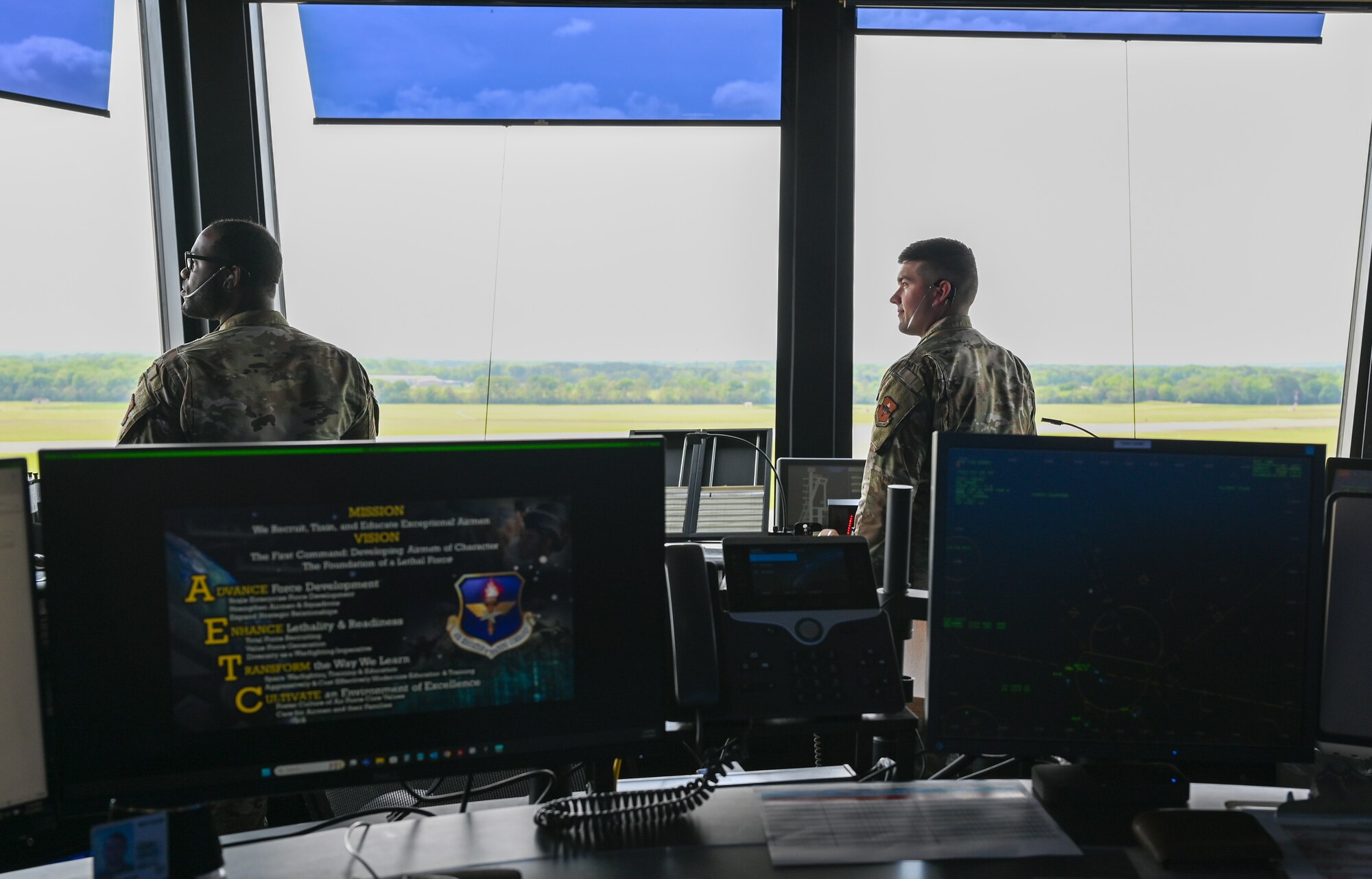 U.S. Air Force Staff Sgt. Daiquan Jackson, left, and U.S. Air Force Senior Airman Logan Jarrett, 42nd Operations Support Squadron air traffic controllers, look towards the airfield at Maxwell Air Force Base, Alabama, April 1, 2025.